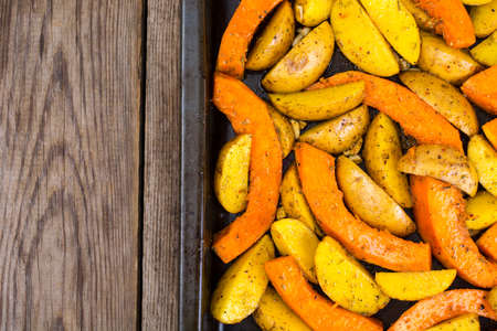 Sliced potatoes and pumpkin for baking in the ovenの写真素材