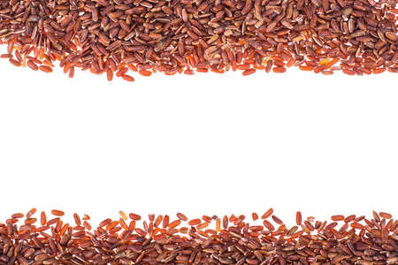 Scattering of red rice on white background closeupの写真素材