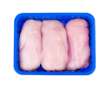 Raw chicken fillet in tray on white backgroundの写真素材