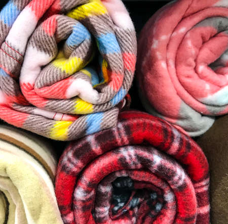 Colored plaids rolls on shelvesの写真素材