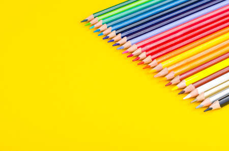 Set of colored pencils for schoolboy on bright background