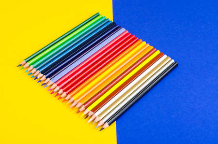 Set of colored pencils for schoolboy on bright backgroundの写真素材