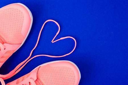 Flat lay pink sneakers on bright background. Casual sport conceptの写真素材