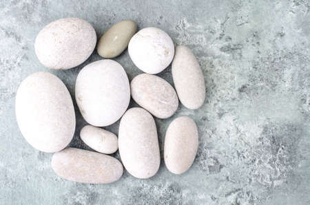 Round light sea stones on gray blue background. Studio Photoの写真素材