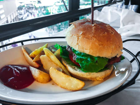 Fast food hamburger, potatoes, ketchup.