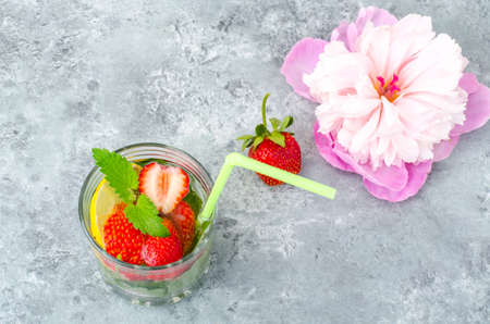 Cold summer drink with strawberries, lemon and mint. Studio Photo