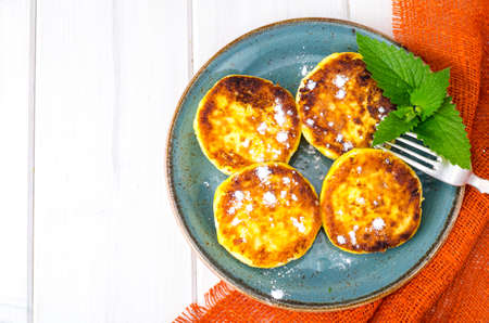 Hot fried delicious cheese cakes with powdered sugar