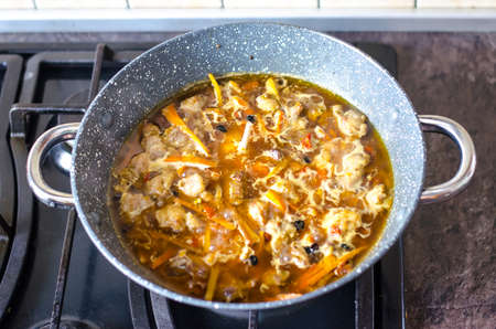 Meat with vegetables in frying pan wok on stove. Studio Photoの写真素材