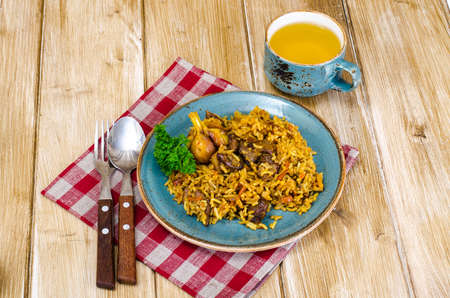 Blue plate with pilaf and meat.の写真素材