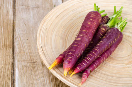Sliced purple carrot on wooden backgroundの写真素材
