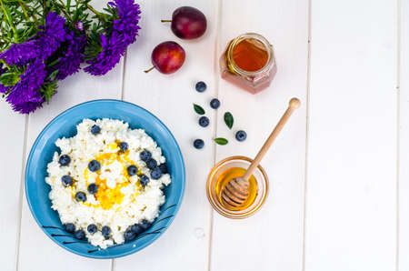 Dairy products in dietary foods. Cottage cheese with fresh berries and honeyの写真素材