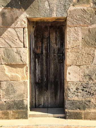Wooden vintage doors in wall of an old building. Studio Photoの写真素材