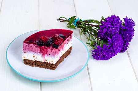 Piece of cake with berries and jelly.