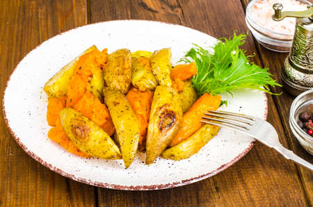 Healthy vegetarian diet food, baked vegetables, pumpkin and potatoes.の写真素材