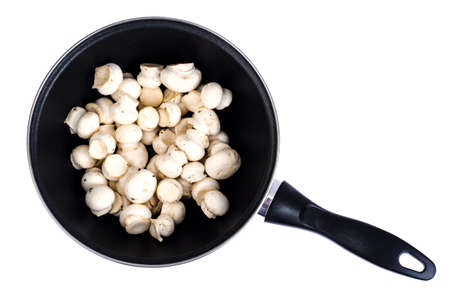 Pan with raw fresh champignons isolated on white background. Studio Photo