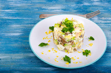 Tasty salad with squid and avocado on blue background. Studio Photoの写真素材