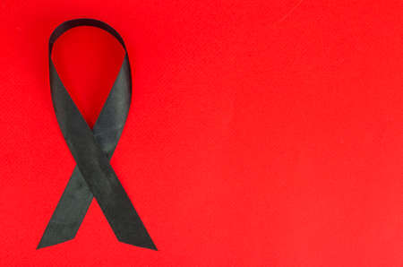 Black ribbon awareness for melanoma and skin cancer. Studio Photo