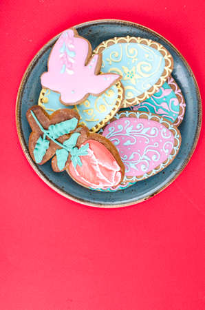 Easter homemade gingerbread on red background. Studio Photo