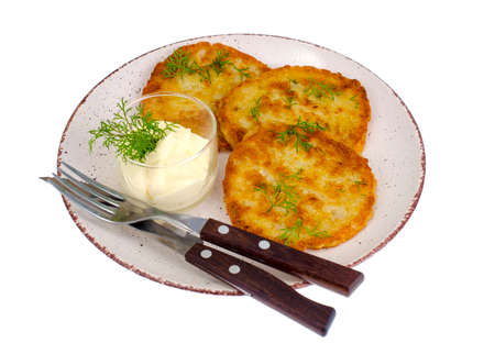 Vegetarian vegetable fried potato pancakes with sauce. Studio Photo