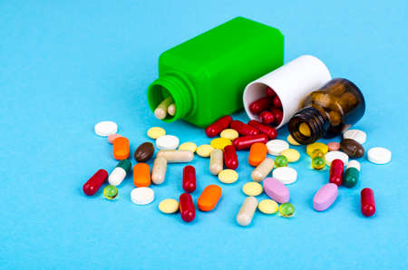 Medical bottle, red pills, treatment for cardiovascular diseases. Studio Photo