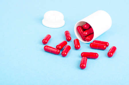 Medicine concept. Scattered capsules from prescription bottle. Studio Photoの写真素材