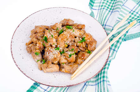 Sliced chicken with sesame seeds on plateの写真素材