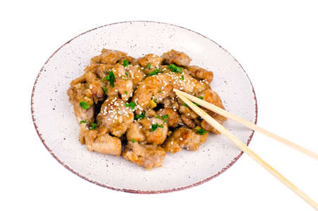Sliced chicken with sesame seeds on plateの写真素材