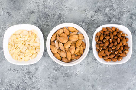 Whole, peeled and sliced almonds, top view.の写真素材