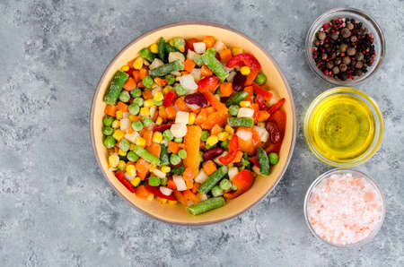 Cooking ingredients of mix frozen vegetables, spices and oil.の写真素材