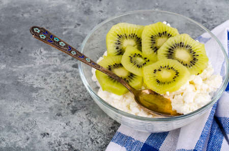 Cottage cheese with kiwi in glass bowlの写真素材