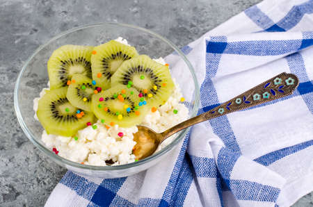Cottage cheese with kiwi in glass bowlの写真素材