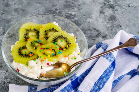 Cottage cheese with kiwi in glass bowlの写真素材