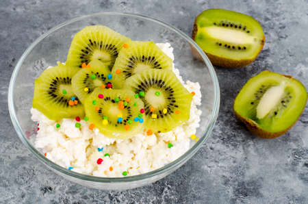 Cottage cheese with kiwi in glass bowlの写真素材