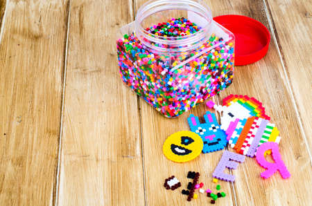 Jar with colored plastic pieces of children's mosaic.の写真素材