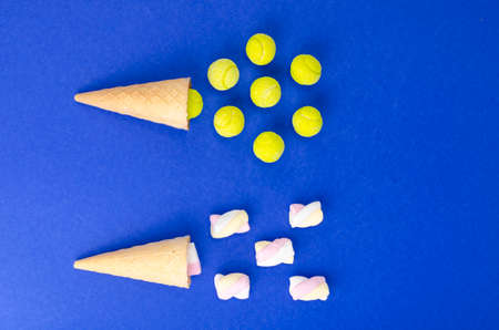 Waffle cone with yellow rubber bands on bright background