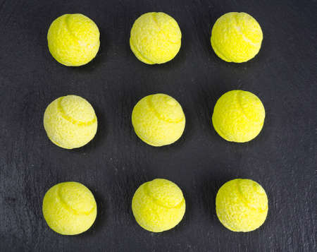 Round balls of chewing candies on black background. Studio Photo