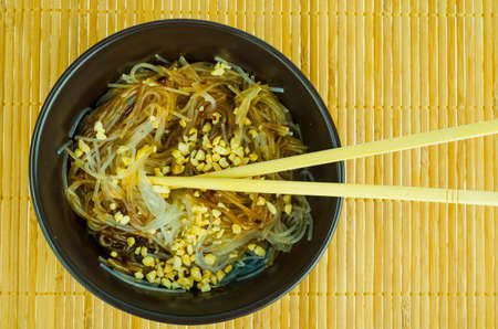 Hot glass noodles with sauce, peanuts, sesame. Studio Photoの写真素材