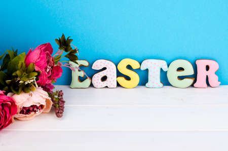 Bright Easter background.  Decoration eggs and colorful letters forming words  EASTER. Celebration...