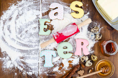 Homemade cookies in form letters EASTER and eggs on old wooden backgroun. Studio Photoの写真素材