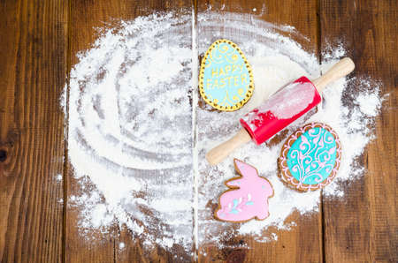 Homemade cookies in form letters EASTER and eggs on old wooden backgroun. Studio Photoの写真素材