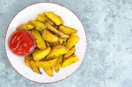 Ruddy golden potato slices in plate on table.