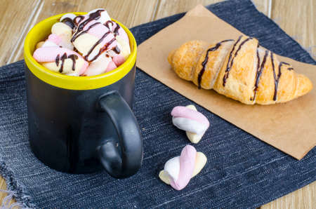 Chocolate croissant and marshmallow in cocoa drink