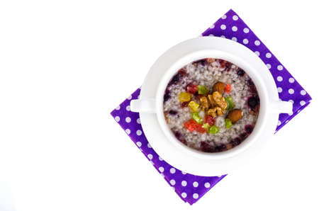 Healthy breakfast. Oatmeal with berries, nuts and candied fruit.の写真素材