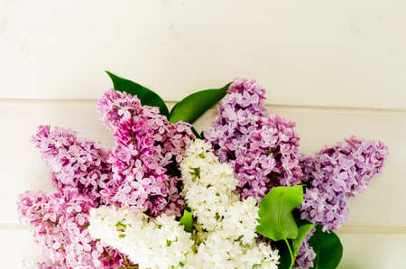 Bouquet of white and purple lilac branches on wooden table. Studio Photoの写真素材