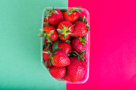 Fresh sweet red strawberries in plastic container.の写真素材