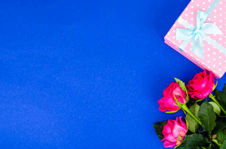 Beautiful bouquet of roses and gift box for holiday