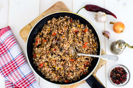 Buckwheat porridge with vegetables in pan