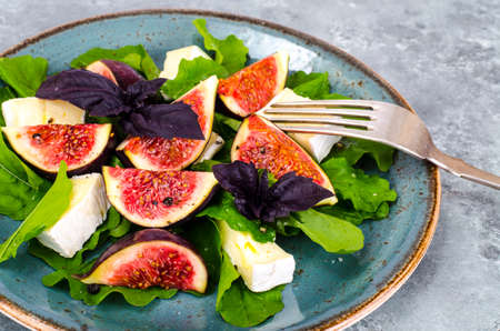 Delicatessen salad with figs and cheese on gray blue backgroundの写真素材