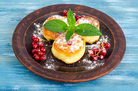 Dairy products, cottage cheese pancakes with powdered sugar and berries