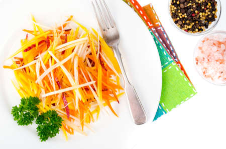 Tasty vegetarian salad of colorful carrots on white background. Studio Photoの写真素材